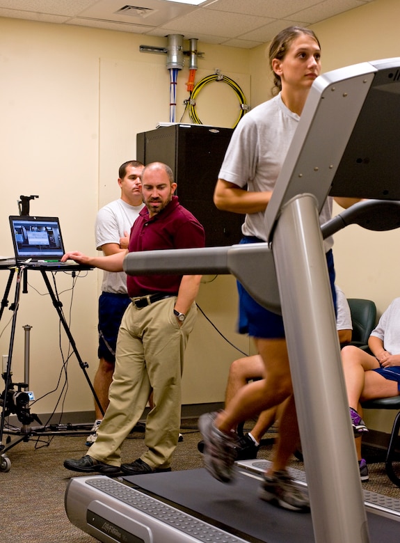 Brent Cowen, a Health and Wellness Center exercise physiologist, studies the running stride of 1st Lt. Kristen Baker, an assistant operations officer from 1st Special Operations Force Support Squadron, during a running clinic in the HAWC at Hurlburt Field, Fla., July 11, 2012. Exercise also improves Airman physical resiliency by reducing stress. (U.S. Air Force photo/Airman 1st Class Michelle Vickers) (RELEASED) 
