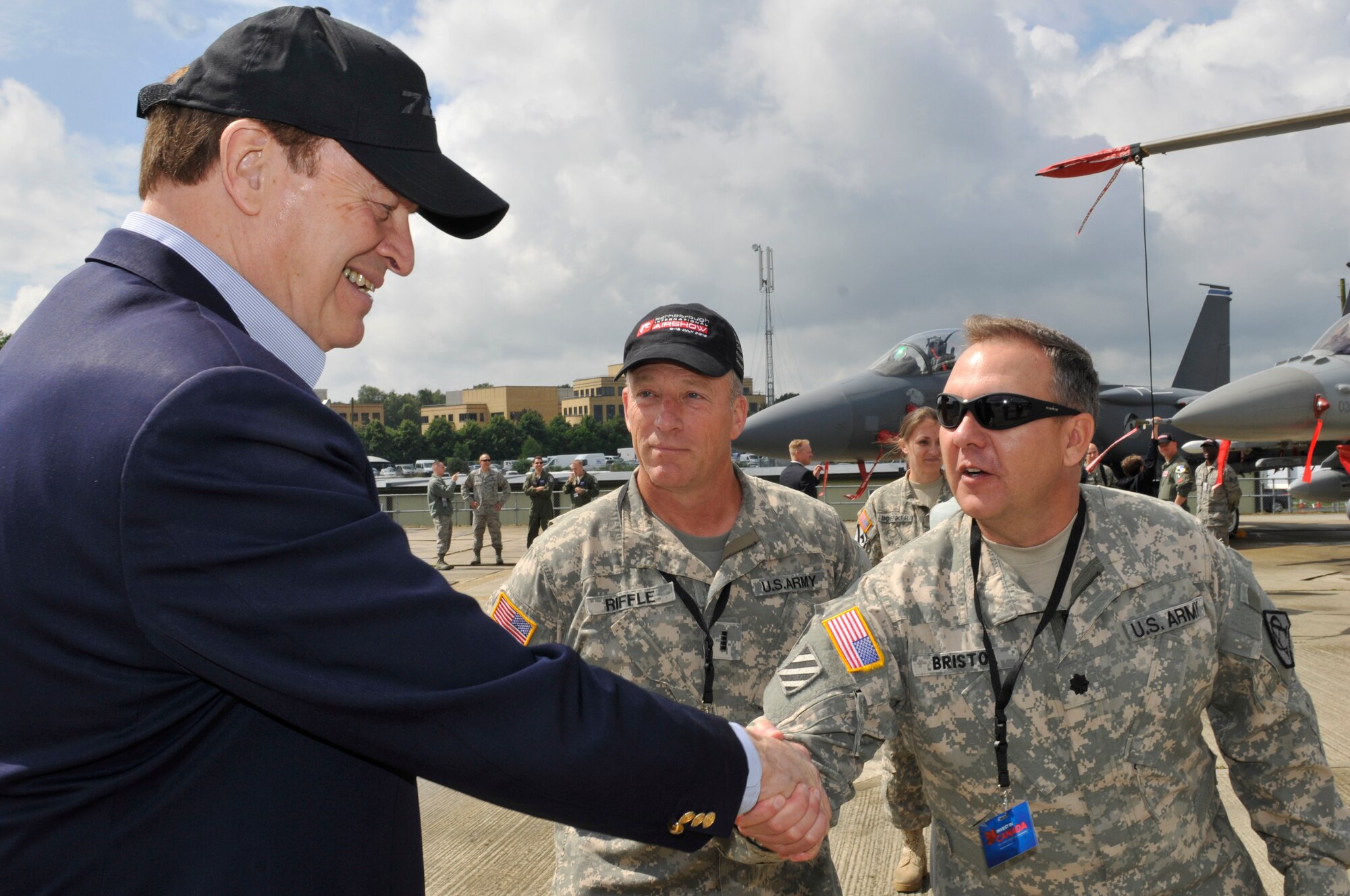 FARNBOROUGH, England - Sen. Richard Shelby of Alabama meets with U.S. Army Lt. Col. Dave Bristol and Chief Warrant Officer Richard Riffle, July 8, 2012, during the Farnborough International Air Show in Farnborough, England. Bristol and Riffle are from the Program Executive Aviation Office out of Redstone Arsenal, Huntsville, Ala. They are part of approximately 90 aircrew and support personnel from bases in Europe and the United States that are participating in the air show. The world renowned air show exhibits the latest in aerospace equipment and technology. (U.S. Air Force photo by Tech. Sgt. Lee A. Osberry Jr.)