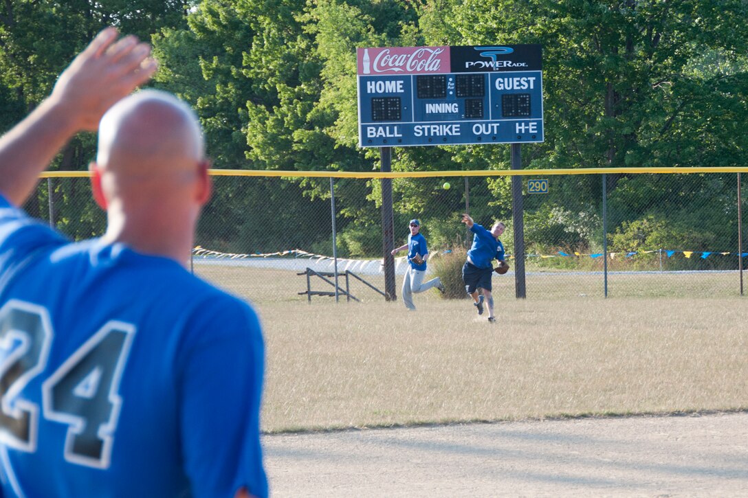 KENT, Ohio -- Staff Sgt. Mark Chambers, 910th Civil Engineer fire fighter awaits Master Sgt. Scott Smith's, 910th Medical Squadron healthcare service manager, throw from outfield to third base during one of the 910th Airlift Wing Air Force Falcons make up game at Allerton Field in Kent, Ohio, July 10, 2012. The Falcons softball team consists of Youngstown Air Reserve Station servicemembers and civilians who participate in this men's summer softball league. (U.S. Air Force photo/Staff Sgt. Megan Tomkins)