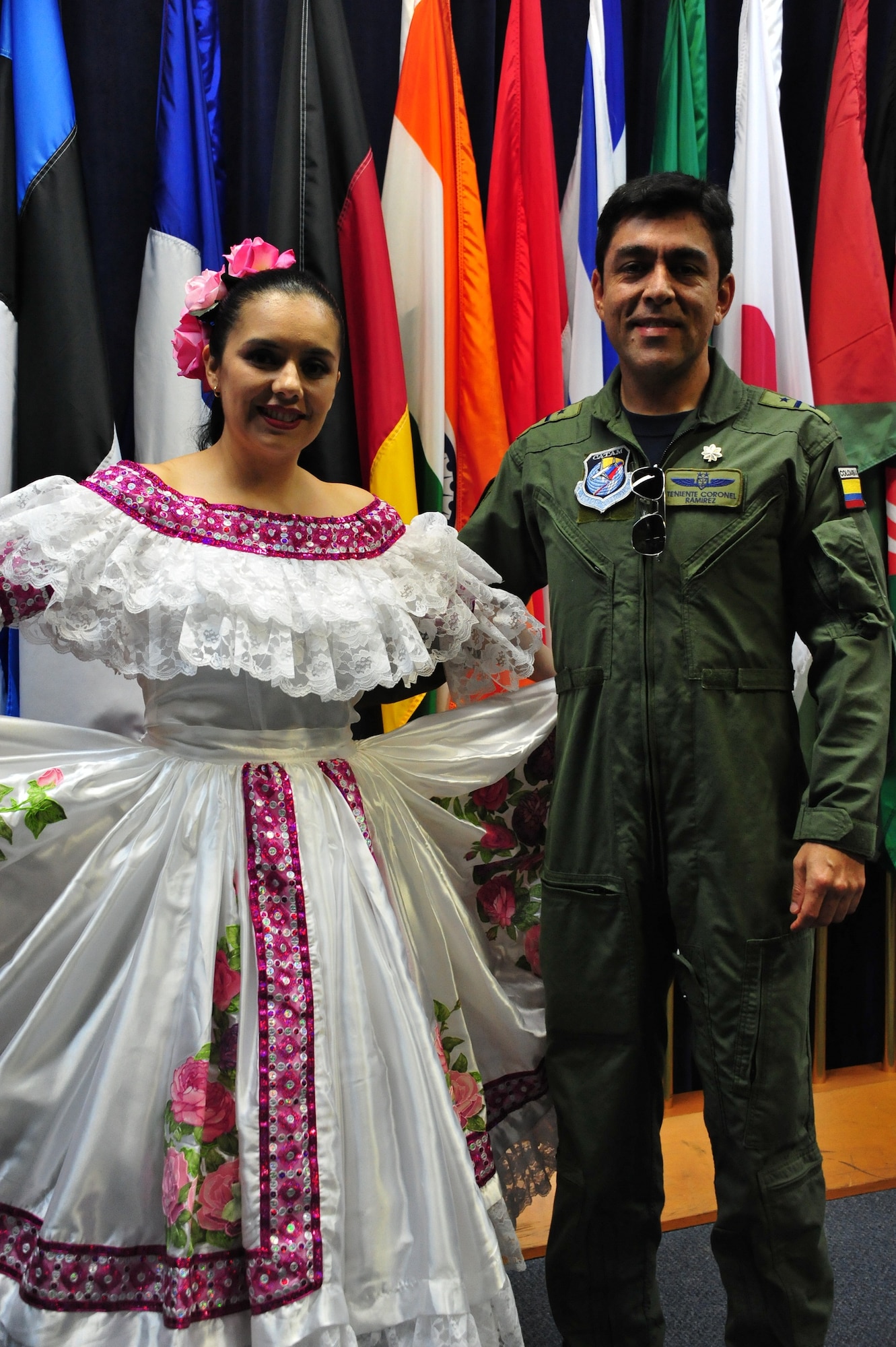 Emilse Julio displays her formal Colombian dress with Colombian air force Lt. Col. Juan Ramirez during the International Family Orientation Program graduation held July 3. IFOP classes are designed to familiarize spouses, children and other family members of International Officers with the customs and culture of the local area and the United States, and gives them a chance to meet and socialize with each other. (U.S. Air Force photo by Airman 1st Class William Blankenship)