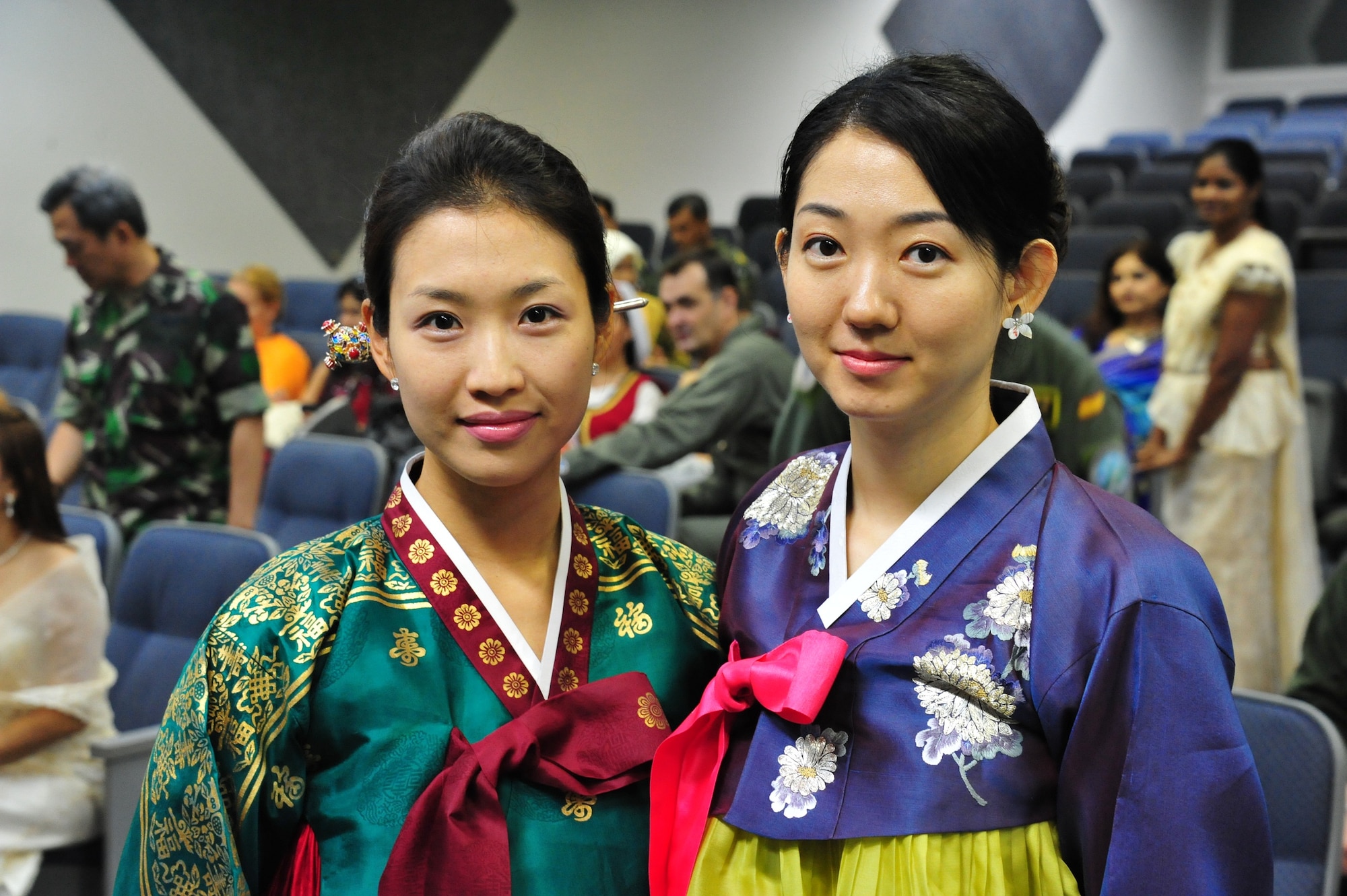 Soojin Choi and Lin Jung display their Hanbok, South Korea's traditional dress wear during the International Family Orientation Program graduation on July 3. IFOP classes are designed to familiarize spouses, children and other family members of International Officers with the customs and culture of the local area and the United States, and gives them a chance to meet and socialize with each other. (U.S. Air Force photo by Airman 1st Class William Blankenship)