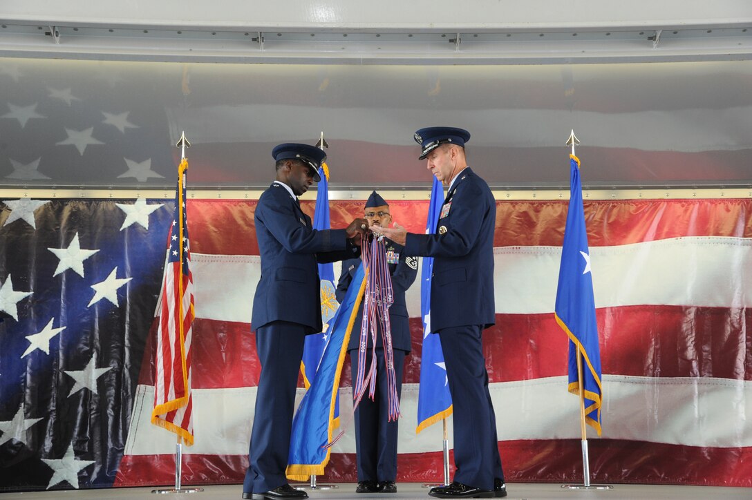 Gen. Edward A. Rice Jr., Air Education and Training Command commander, and Maj. Gen. Mark Solo, 19th AF commander, place the outstanding unit award streamer on the 19th AF flag at the inactivation ceremony held at Joint Base San Antonio-Randolph, Texas, July 12. (U.S. Air Force photo by Rich McFadden) 