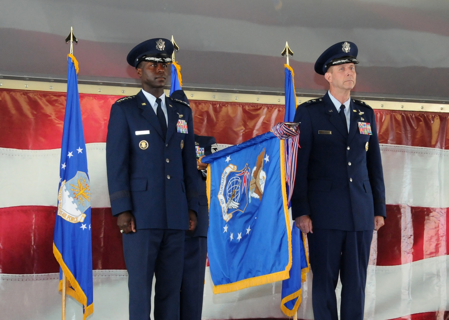 Gen. Edward A. Rice Jr. (left) Air Education and Training Command commander, and Maj. Gen. Mark Solo, 19th Air Force commander, furl the 19th AF flag at the inactivation ceremony held at Joint Base San Antonio-Randolph, Texas, July 12. (U.S. Air Force photo by Melissa Peterson)
