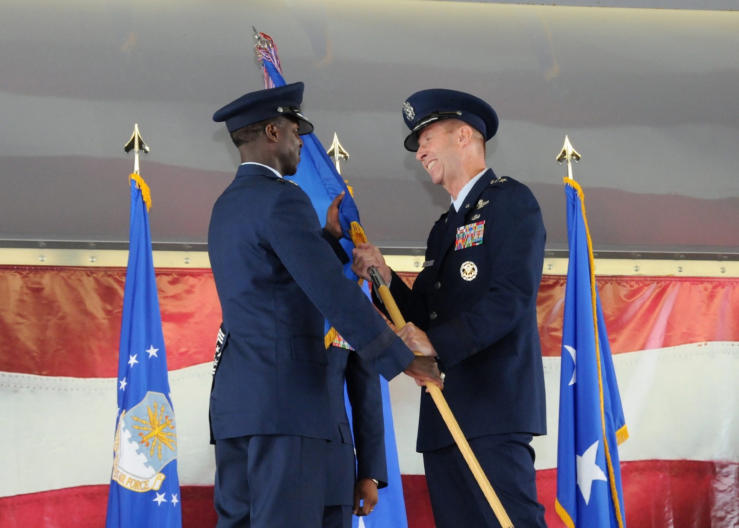 Maj. Gen. Mark Solo (right), 19th Air Force commander, passes the 19th AF flag to Gen. Edward A. Rice Jr., Air Education and Training Command commander, to relinquish command during the inactivation ceremony held at Joint Base San Antonio, Texas, July 12. (U.S. Air Force photo by Melissa Peterson)