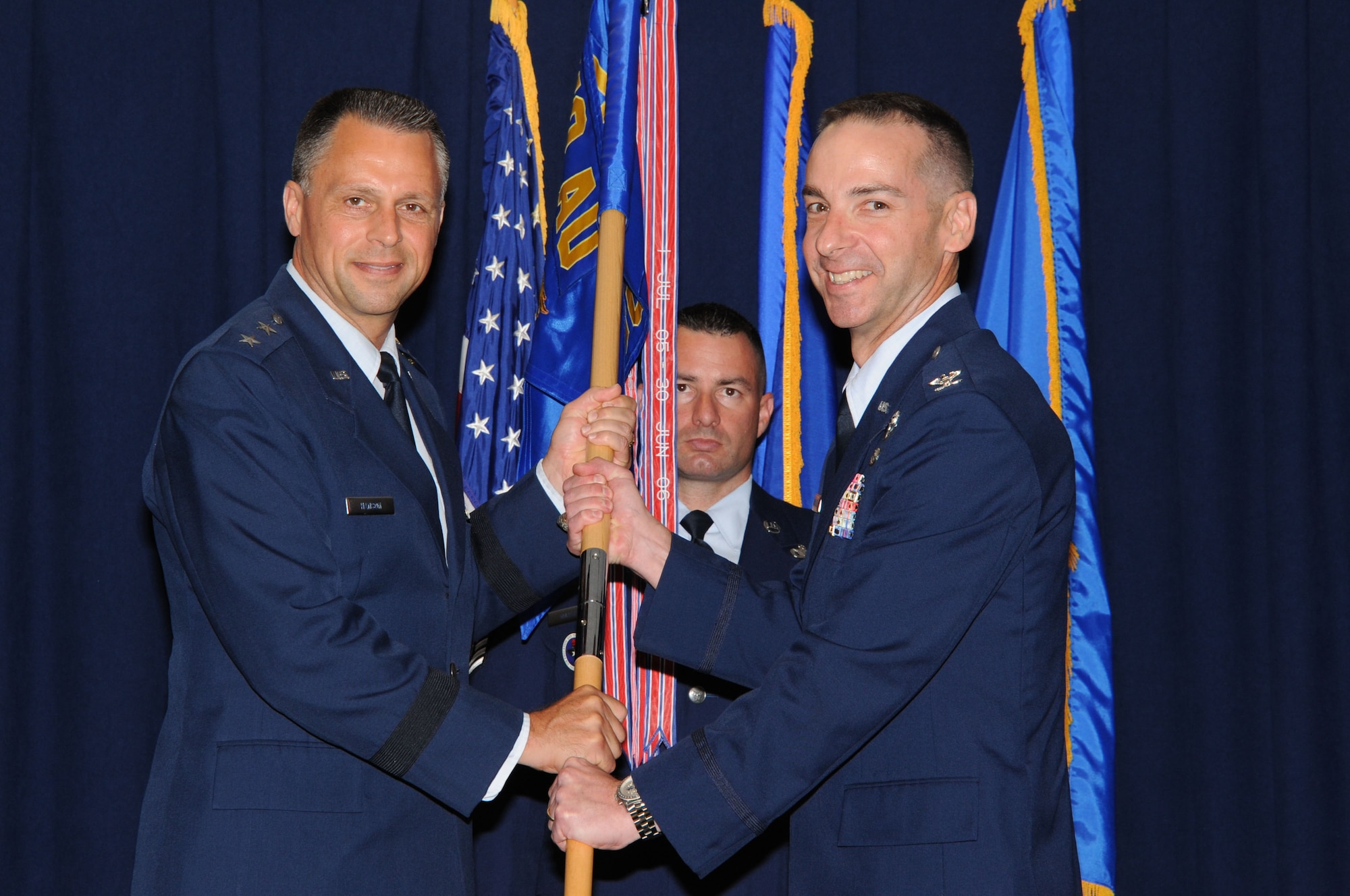 Maj. Gen. Scott Hanson passes the colors to Col. Mark Czelusta, incoming commander of the Squadron Officer College, during the change of command ceremony July 3 at Husband Auditorium. (Air Force photo by Bud Hancock)