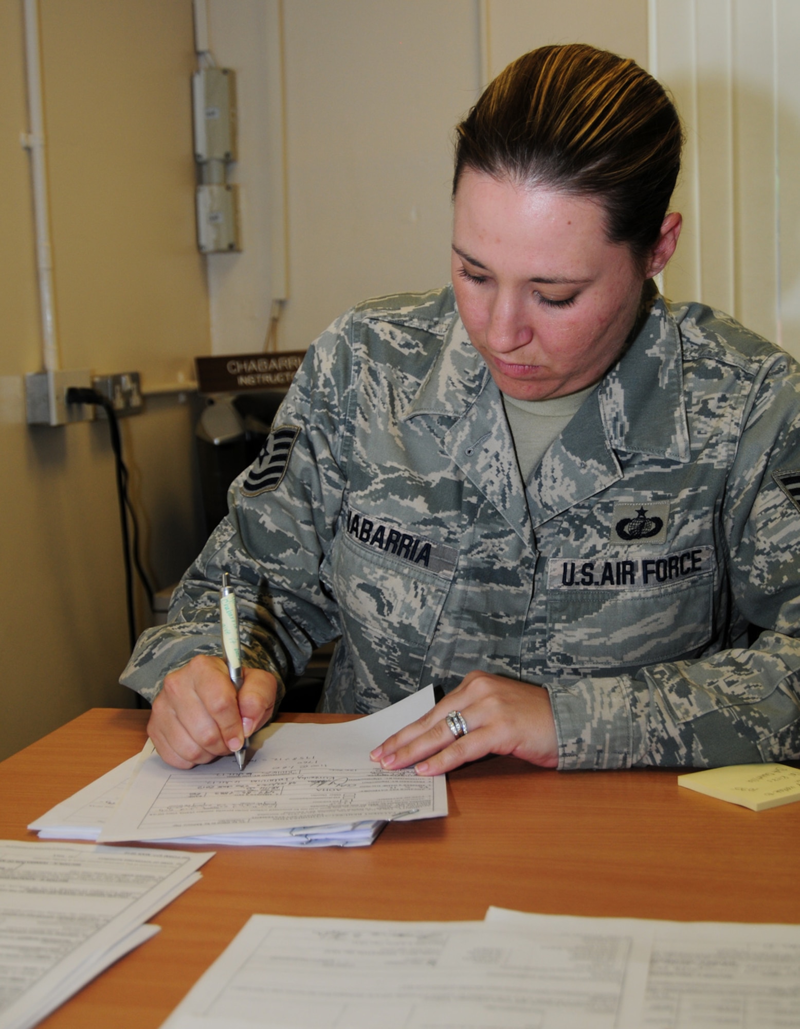 RAF MILDENHALL, England – Tech. Sgt. Kimberly Chabarria, 100th Comptroller Financial Services NCO in charge, checks applications for advance pay for housing allowance to ensure they are properly filled out July 9, 2012. (U. S. Air Force photo/Karen Abeyasekere)
