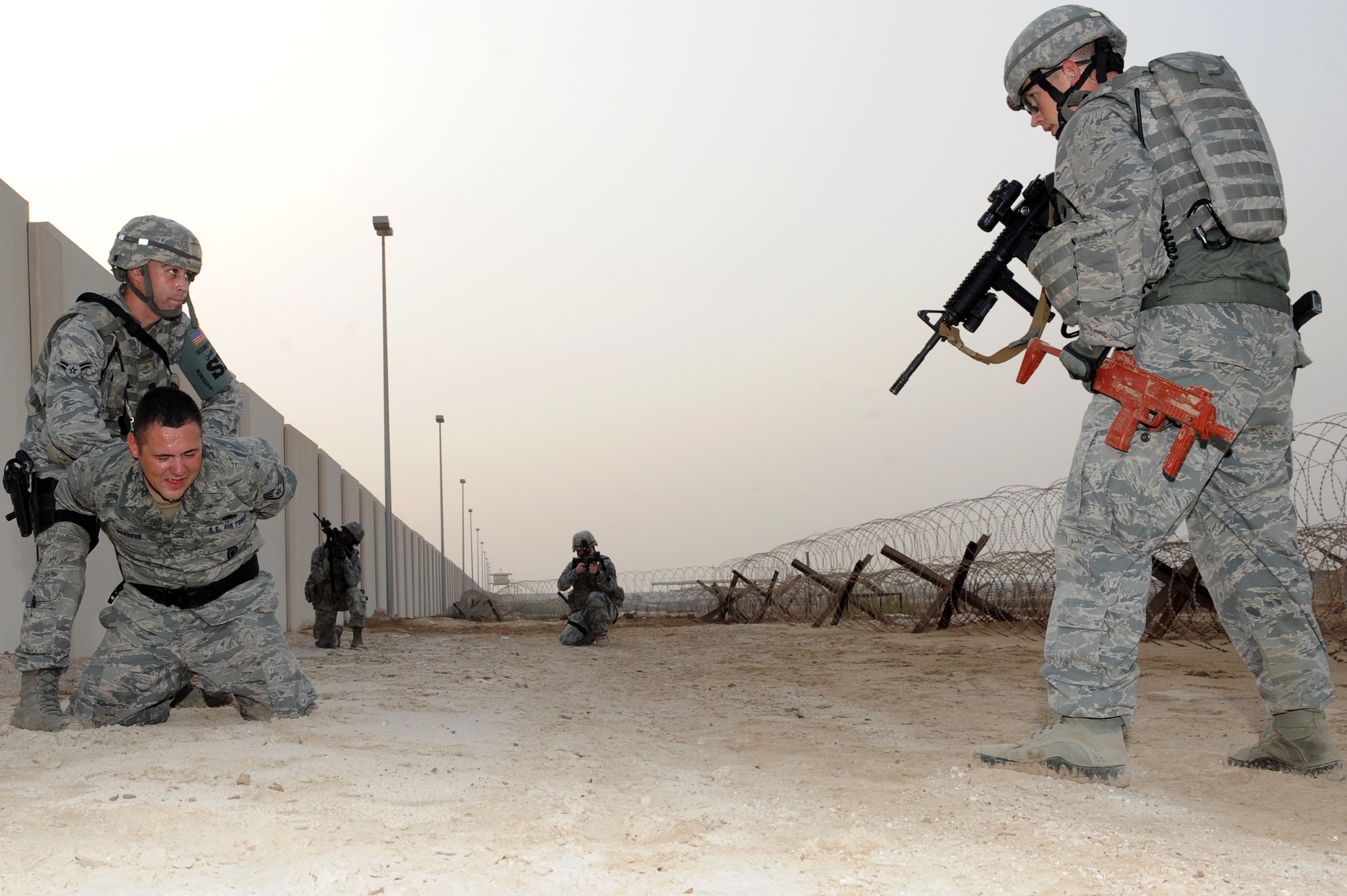 SOUTHWEST ASIA - Members of the 380th Expeditionary Security Forces Squadron Quick Response Force take down an intruder during an exercise July 12, 2012. The QRF responds to any hostile threat against the base in five minutes or less. (U.S. Air Force photo/Master Sgt. Scott MacKay)