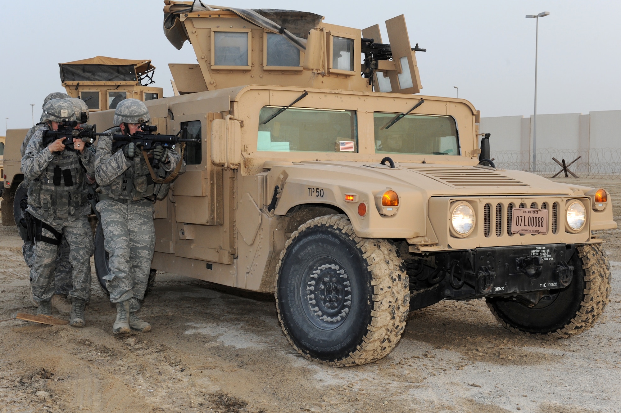 SOUTHWEST ASIA -Members of the 380th Expeditionary Security Forces Squadron Quick Response Force prepare to move against an intruder on base during an exercise July 12, 2012. The QRF conducts exercises every shift to prepare to respond to any hostile action against the base.(U.S. Air Force photo/Master Sgt. Scott MacKay)