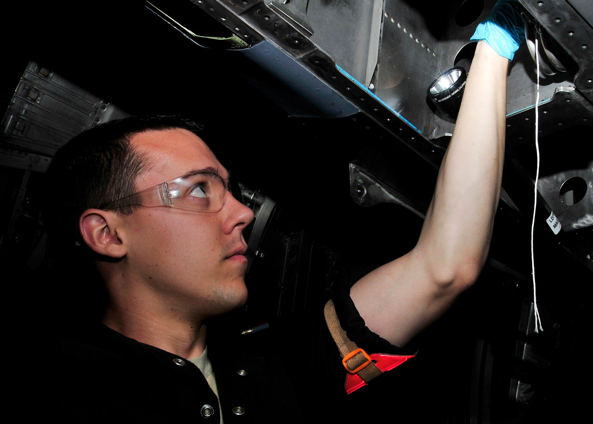 ROYAL AIR FORCE LAKENHEATH, England - Airman 1st Class Andrew Kiel, 48th Equipment Maintenance Squadron inspection section apprentice, checks a compartment underneath an F-15, July 11, 2012. Kiel was nominated for a Liberty Spotlight because he displays the core value of "Excellence in All We Do." (U.S. Air Force photo by Senior Airman Tiffany M. Deuel)