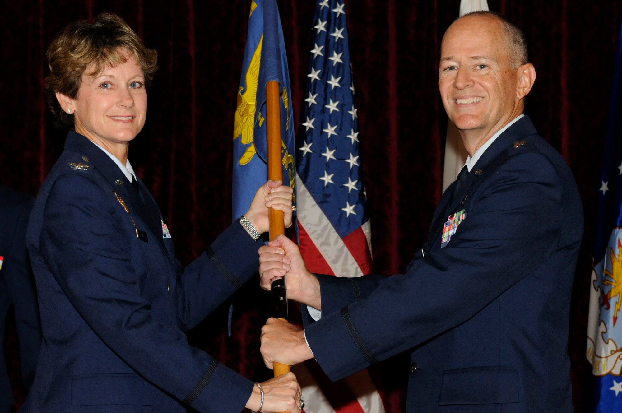 U.S. Air Force Lt. Col. Robin Fontenot, newly appointed commander of the 18th Dental Squadron, accepts the guidon during a change of command ceremony on Kadena Air Base, Japan, July 13, 2012. Fontenot comes from Mountain Home Air Force Base, Idaho, where he was the commander of the 366th Dental Squadron. (U.S. Air Force photo/Airman Tara A. Williamson)
