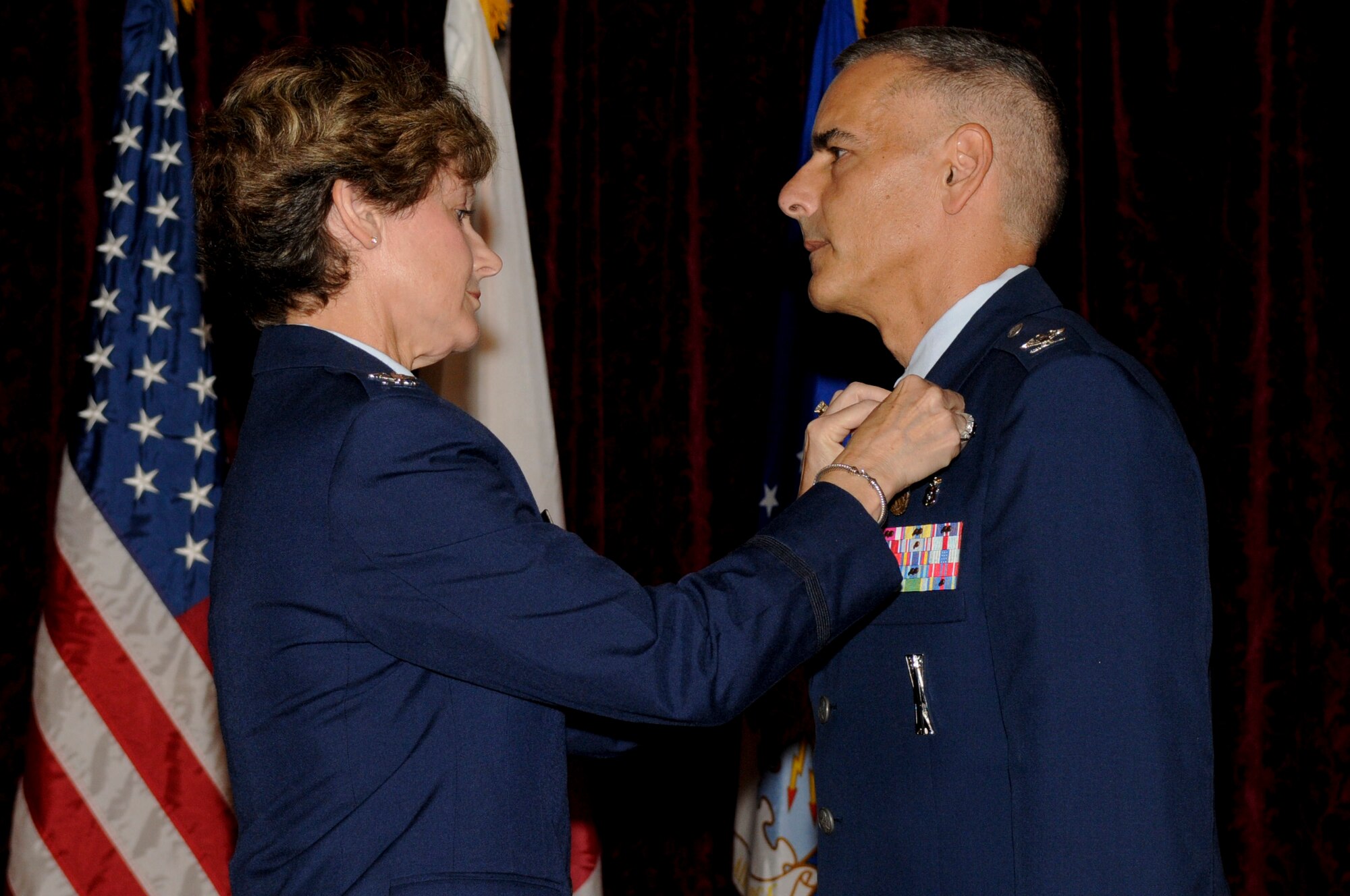 U.S. Air Force Col. Barbara King, 18th Wing Medical Group commander, pins the Air Force Meritorious Service Medal on U.S. Air Force Col. Salvatore Cutino, former 18th Dental Squadron commander, during a change of command ceremony on Kadena Air Base, Japan, July 13, 2012. As commander, Cutino had directed four flights and clinical operations in general dentistry, endodontics, pediatric dentistry, orthodontics, oral surgery, periodontics and prosthodontics. (U.S. Air Force photo/Airman Tara A. Williamson)