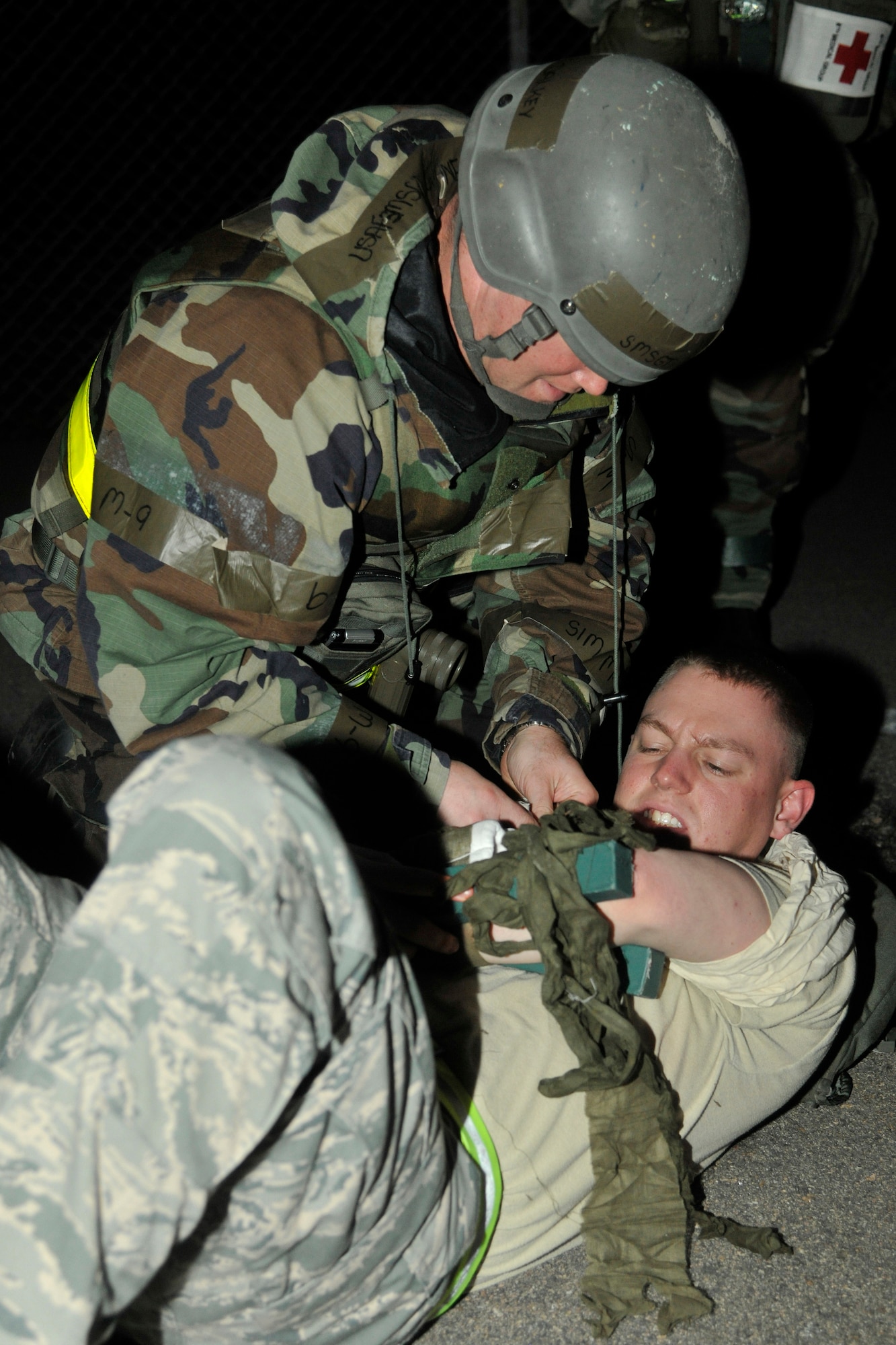 Senior Master Sgt. Shane Dalkey, left, 8th Logistics Readiness Squadron, places a splint on Senior Airman Andrew Holcomb, 8th Security Forces Squadron, at Kunsan Air Base, Republic of Korea, July 11, 2012. Kunsan Airmen practice operational readiness exercises to maintain proficiency for wartime conditions. (U.S. Air Force photo/Senior Airman Marcus Morris)