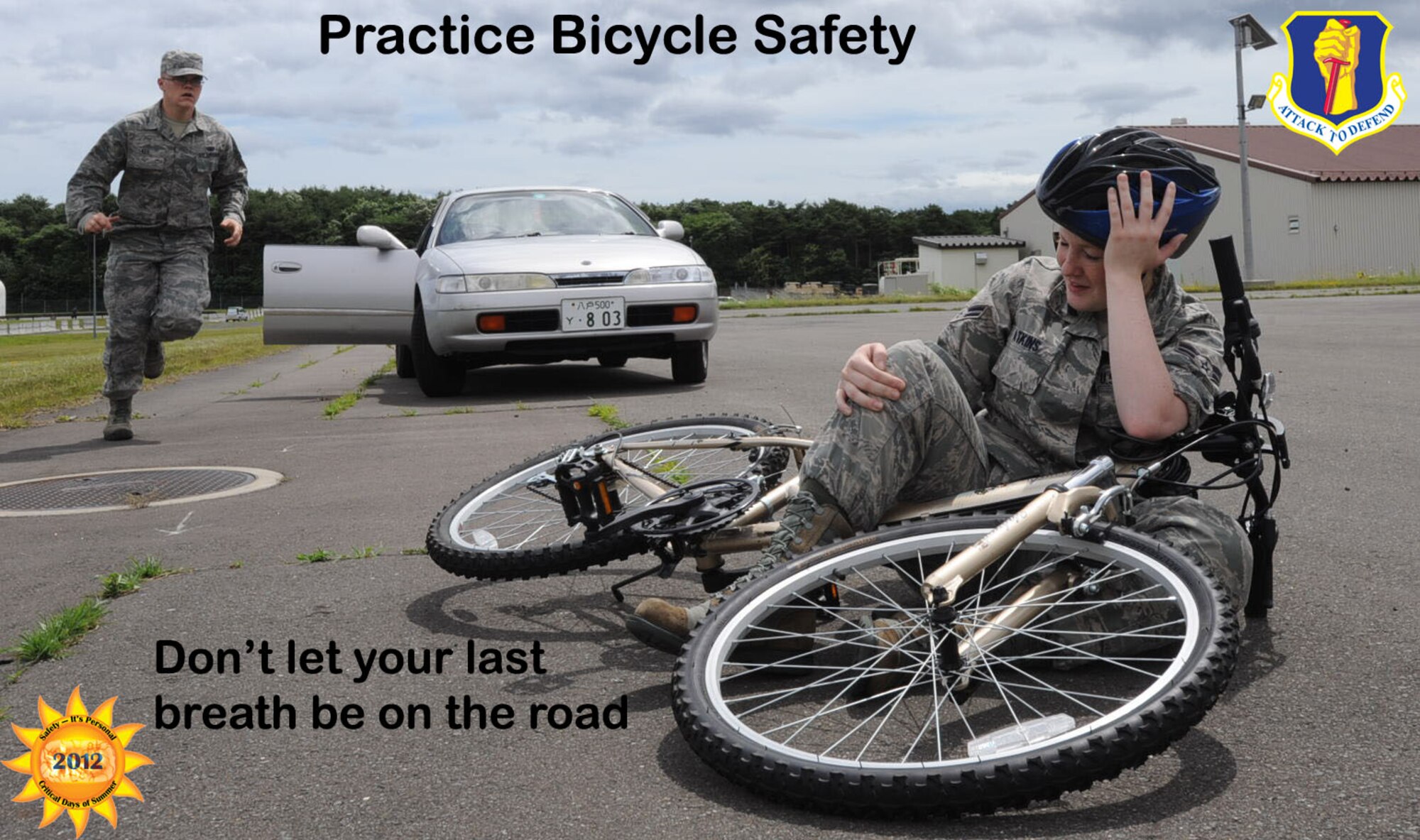 U.S. Air Force Airman 1st Class Kia Atkins, 35th Fighter Wing public affairs photographer, simulates being hit by a vehicle while riding a bike at Misawa Air Base, Japan, July 13, 2012. When riding a bicycle, being constantly aware of your surroundings is a part of taking road safety precautions. (U.S. Air Force illustration by Airman 1st Class Kenna Jackson/Released)