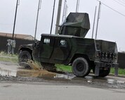 Members of the 8th Security Forces Squadron roll through a mud puddle in a Humvee during exercise Beverly Midnight 12-03 on Kunsan Air Base, Republic of Korea, July 11, 2012. They were responding to a simulated ground attack by hostile forces designed to test their ability to quickly and effectively respond. (U.S. Air Force photo/Staff Sgt. Jonathan Fowler)