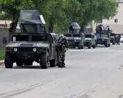 Members of the 8th Security Forces Squadron take cover behind a Humvee during exercise Beverly Midnight 12-03 on Kunsan Air Base, Republic of Korea, July 11, 2012. They were responding to a simulated ground attack by hostile forces designed to test their ability to quickly and effectively respond. (U.S. Air Force photo/Staff Sgt. Jonathan Fowler)