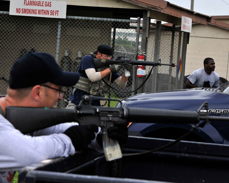 Opposing-forces role players fire from behind cover during a simulated attack for exercise Beverly Midnight 12-03 on Kunsan Air Base, Republic of Korea, July 11, 2012. The scenario tested the base’s ability to respond effectively to a ground attack from hostile forces. (U.S. Air Force photo/Staff Sgt. Jonathan Fowler)