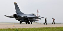 An F-16 Fighting Falcon is inspected before taking flight during exercise Beverly Midnight 12-03 on Kunsan Air Base, Republic of Korea, July 11, 2012. The exercise is designed to test the base’s operational readiness for its wartime mission. (U.S. Air Force photo/Staff Sgt. Jonathan Fowler)