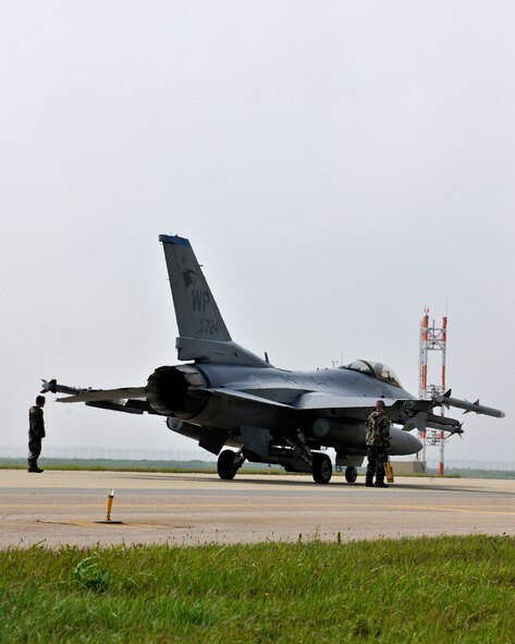 An F-16 is inspected before taking flight during exercise Beverly Midnight 12-03 on Kunsan Air Base, Republic of Korea, July 11, 2012. The exercise is designed to test the base’s operational readiness for its wartime mission. (U.S. Air Force photo/Staff Sgt. Jonathan Fowler)