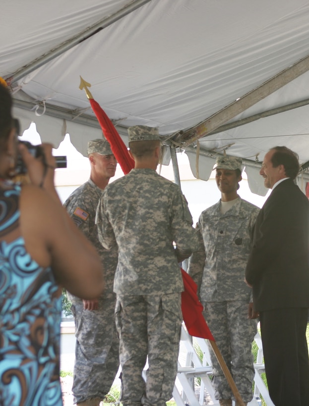 Brig. Gen. Michael Wehr (left) waits as outgoing Albuquerque District Commander Lt. Col. Jason Williams prepares to pass the command flag to incoming District Commander Lt. Col. Antoinette Gant during a ceremony July 12.  Also pictured (right) is the District's civilian Deputy for Planning, Projects and Program Management, John D'Antonio.   