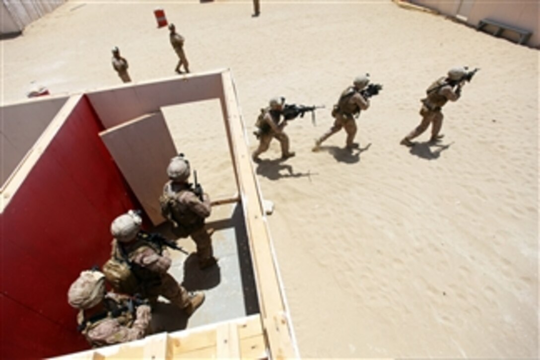 U.S. Marines from Alpha Company, Battalion Landing Team 1st Battalion, 2nd Marine Regiment, 24th Marine Expeditionary Unit, move between buildings during close-quarters combat training at the Udairi Range in Kuwait on July 3, 2012.  