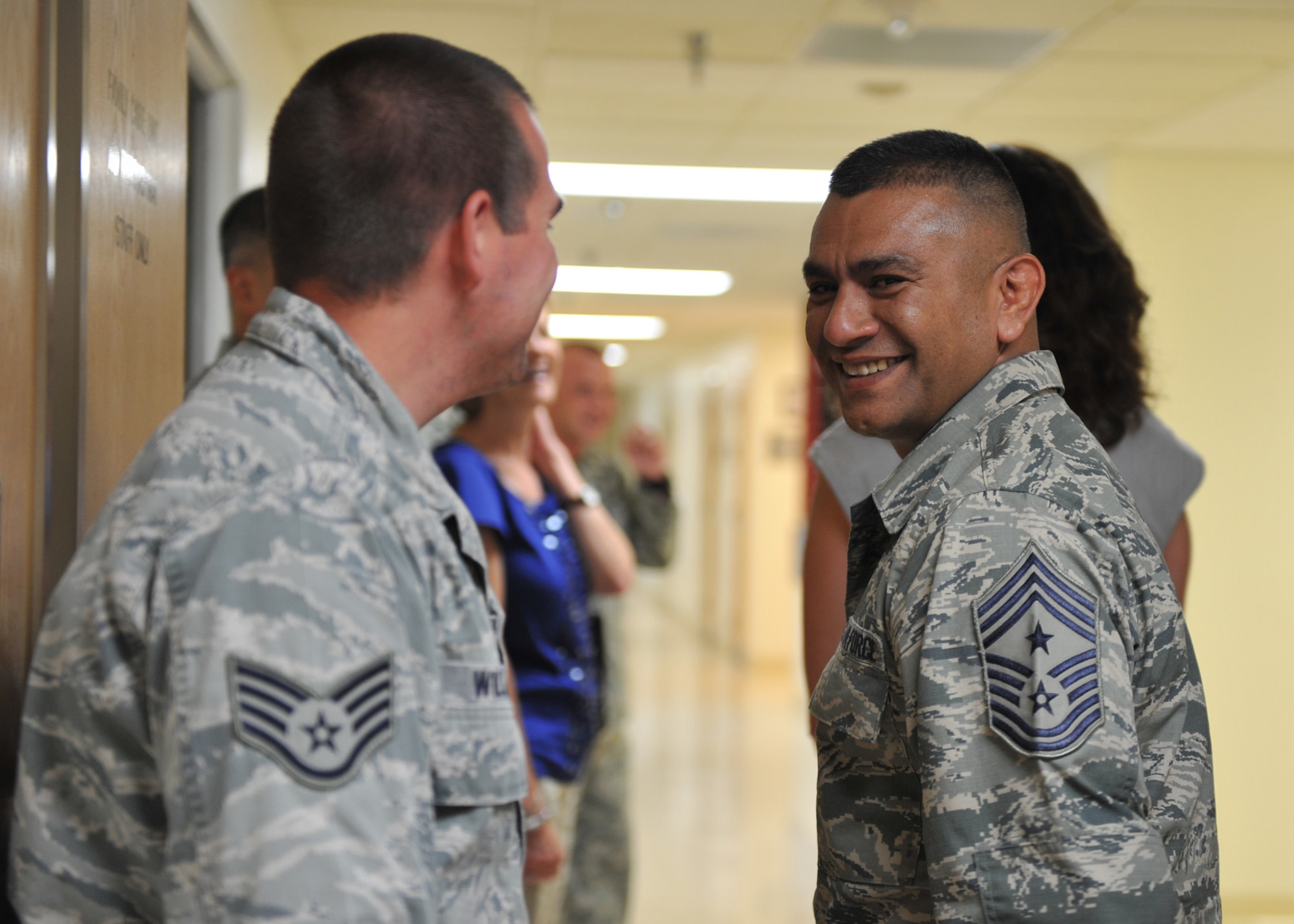 U.S. Air Force Chief Master Sgt. Gerardo Tapia Jr., 12th Air Force command chief, smiles to a staff sergeant July 10, 2012, at Mountain Home Air Force Base, Idaho. The first stop of their visit was to the 366th Medical Group to see a demonstration on the care provided during child delivery. (U.S. Air Force photo/Airman 1st Class Heather Hayward)