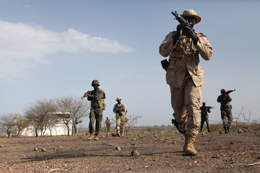 A group of African nations participating in Exercise Western Accord 2012, practices movement to contact at military operation on urban terrain training, July 13. U.S. service members, primarily Reservists from the Marines, Army, Navy, and Air Force are taking part in WA-12 -- a multi-lateral exercise with Senegalese and several Western African nations.  The training exercise runs from June 26 – July 24 and involves Armed Forces of Senegal, Burkina Faso, Guinea, Gambia and France.  (USMC photo by Lance Cpl. Jessica DeRose)