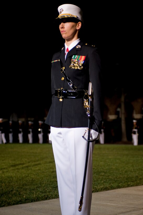 Maj. Sarah Armstrong, a Marine Barracks Washington parade commander, stands at attention after dismissing the parade staff near the end of a Friday Evening Parade here July 13.