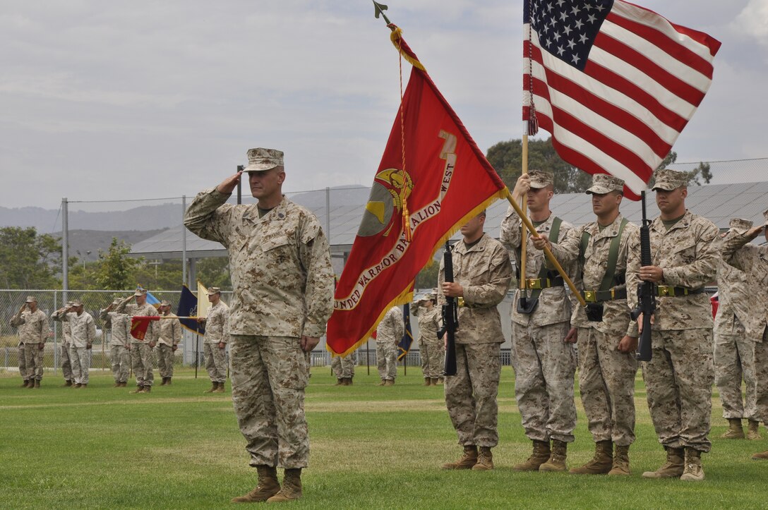 Sgt. Maj. Mark J. O’loughlin salutes for the playing of the national anthem during the post and relief ceremony for Wounded Warrior Battalion West, held concurrently with his retirement ceremony at the 27 Area Hospital softball field, July 13. O’loughlin served as an outstanding Marine with dedicated service to his country and Corps since Oct. 7, 1982 . He  was relieved of his duties by Sgt. Maj. William R. Shaw.