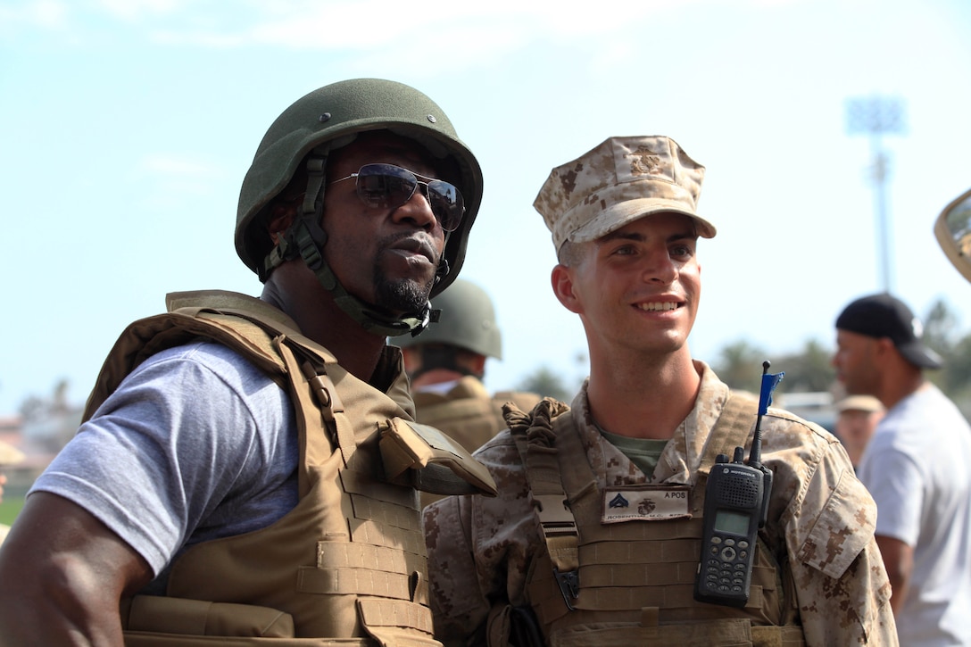Terry Crews, actor, poses with Cpl. Michael C. Rosenthal, motor-transportation operator, Alpha Company, 1st Marine Division, Marine Corps Base Camp Pendleton, Jul. 13. Crews, Randy Couture, mixed martial artist and actor, Dolph Lundgren, actor, and Arnold Schwarzenegger were all on Cam Pendleton for the premiere of “The Expendables 2.”