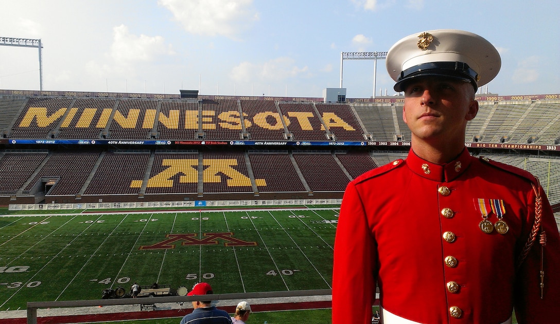 Cpl. Sean Maloney, a contrabass bugler with The Commandant's Own, watches music enthusiasts arrive at TCF Bank Stadium July 14 for DCI Minnesota. Maloney, 26, from Columbus, attended the event with Recruiting Station Twin Cities to look for potential Marine musicians. Maloney acquired a bachelor's degree in music education from Ohio State in 2010. He shipped off to boot camp two weeks after the graduation ceremony.