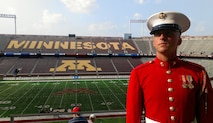 Cpl. Sean Maloney, a contrabass bugler with The Commandant's Own, watches music enthusiasts arrive at TCF Bank Stadium July 14 for DCI Minnesota. Maloney, 26, from Columbus, attended the event with Recruiting Station Twin Cities to look for potential Marine musicians. Maloney acquired a bachelor's degree in music education from Ohio State in 2010. He shipped off to boot camp two weeks after the graduation ceremony.