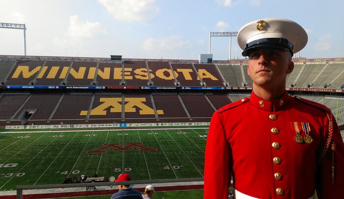 Cpl. Sean Maloney, a contrabass bugler with The Commandant's Own, watches music enthusiasts arrive at TCF Bank Stadium July 14 for DCI Minnesota. Maloney, 26, from Columbus, attended the event with Recruiting Station Twin Cities to look for potential Marine musicians. Maloney acquired a bachelor's degree in music education from Ohio State in 2010. He shipped off to boot camp two weeks after the graduation ceremony.