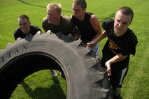 Aspiring Marines from three substations with Recruiting Station Twin Cities near the finish line of a tire-flip exercise during their monthly pool function on July 14. Recruiting Substations Burnsville, Mankato and Rochester hold a pool function together at least once a year.