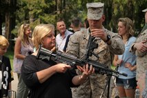 Lance Cpl. Andy Ness shows his mother, Cindy, the inside of an M249 squad automatic weapon during his unit's family day on July 14. Ness, a 20-year-old sophomore at Normandale Community College, is a reserve Marine with Military Police Company Twin Cities.