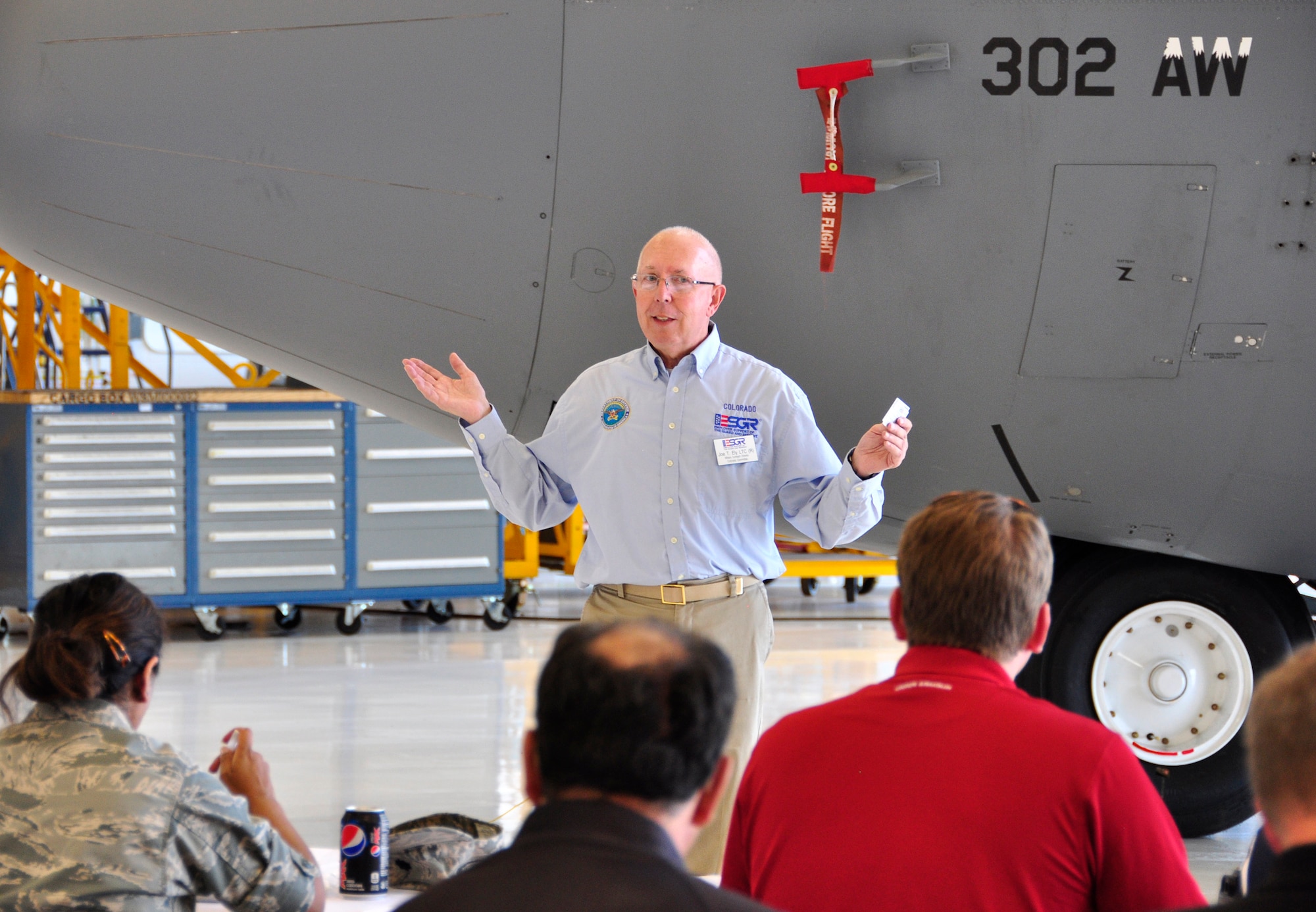 Air Force Col. (ret.) Joe Ely (center) briefs civilian employers on how the Colorado Chapter of the Employer Support for the Guard and Reserve facilitates and promotes a cooperative culture of employer support, July 13 at Peterson Air Force Base, Colo. A total of 26 employers  attended the 302nd Airlift Wing's annual Employer Appreciation Day, which recognizes the support of Reservists' civilian employers. The 302nd AW is based at Peterson Air Force Base in Colorado Springs, Colo. (U.S. Air Force photo/Staff Sgt. Stephen J. Collier).