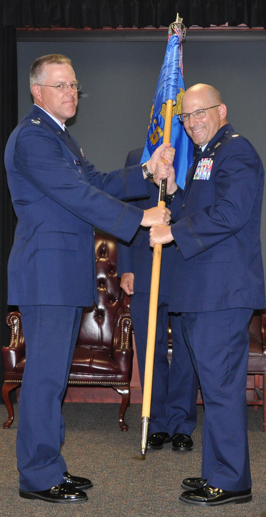 Col. Paul R. Wietbrock, deputy commander, 931st Air Refueling Group,
presents the Civil Engineer Squadron guidon to incoming 931st CES commander, Lt. Col. Doug DeMatthew, during a change of command ceremony at McConnell Air
Force Base, Kan., July 14. DeMatthew assumed command of the 931st CES,
taking the place of outgoing commander, Lt. Col. Erin M. Manning. (U.S. Air Force
photo by Staff Sgt. Carrie M. Peasinger) 
