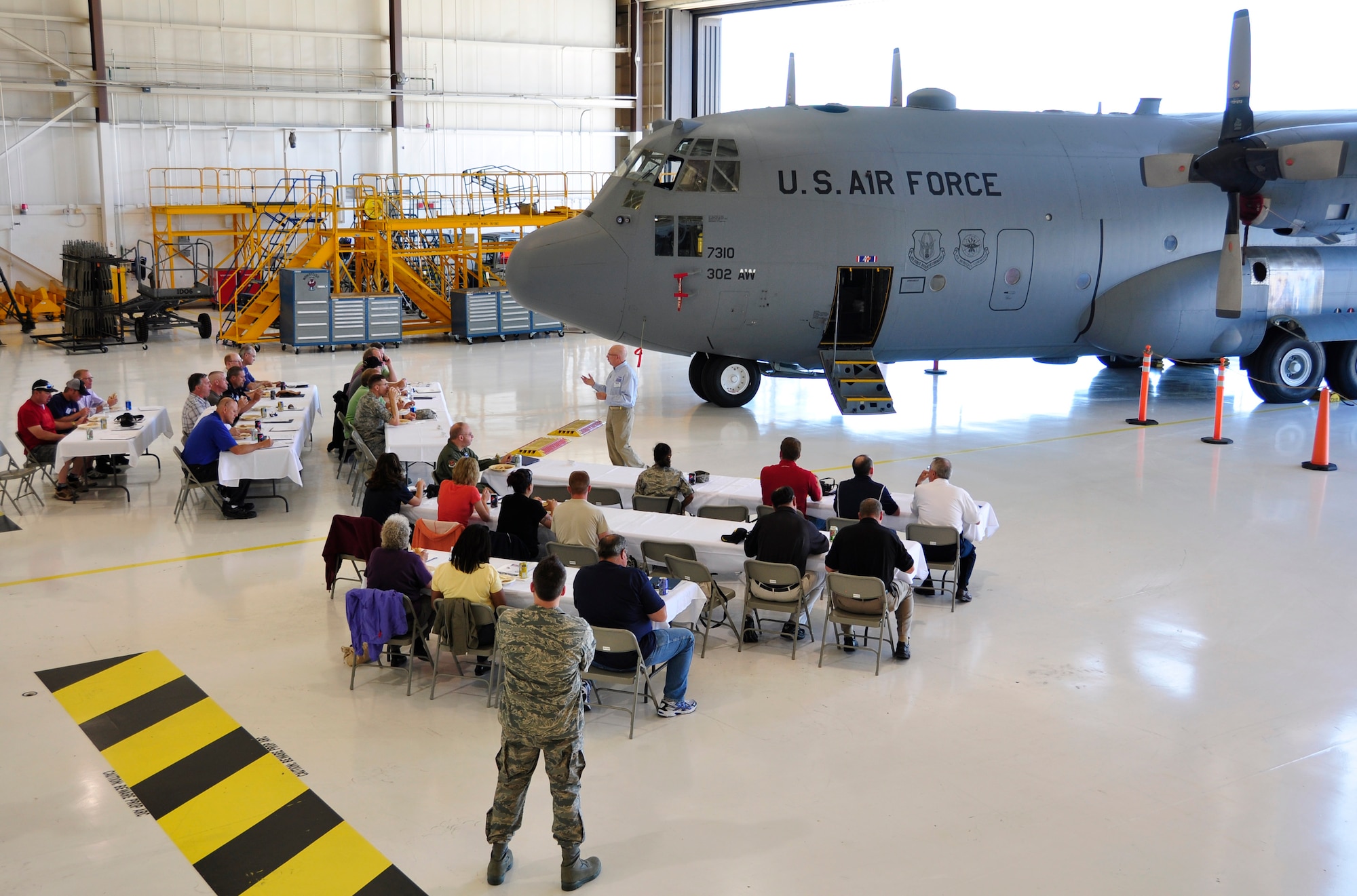 Air Force Col. (ret.) Joe Ely (center) briefs civilian employers on how the Colorado Chapter of the Employer Support for the Guard and Reserve facilitates and promotes a cooperative culture of employer support, July 13 at Peterson Air Force Base, Colo. A total of 26 employers attended the 302nd Airlift Wing's annual Employer Appreciation Day, which recognizes the support of Reservists' civilian employers. The 302nd AW is based at Peterson Air Force Base in Colorado Springs, Colo. (U.S. Air Force photo/Staff Sgt. Stephen J. Collier).