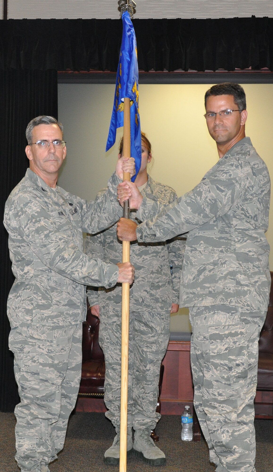 Col. Donald C. Robison, deputy commander for maintenance, 931st Air Refueling
Group, presents the 931st Maintenance Operations Flight guidon to incoming MOF  commander, Maj. John B. Schloss, during a change of command ceremony at McConnell Air Force Base, Kan., July 14. Schloss assumes command of the 931st MOF, taking the place of outgoing commander, Lt. Col. Bradley Garcia. (U.S. Air Force photo by Staff Sgt. Carrie M. Peasinger) 
