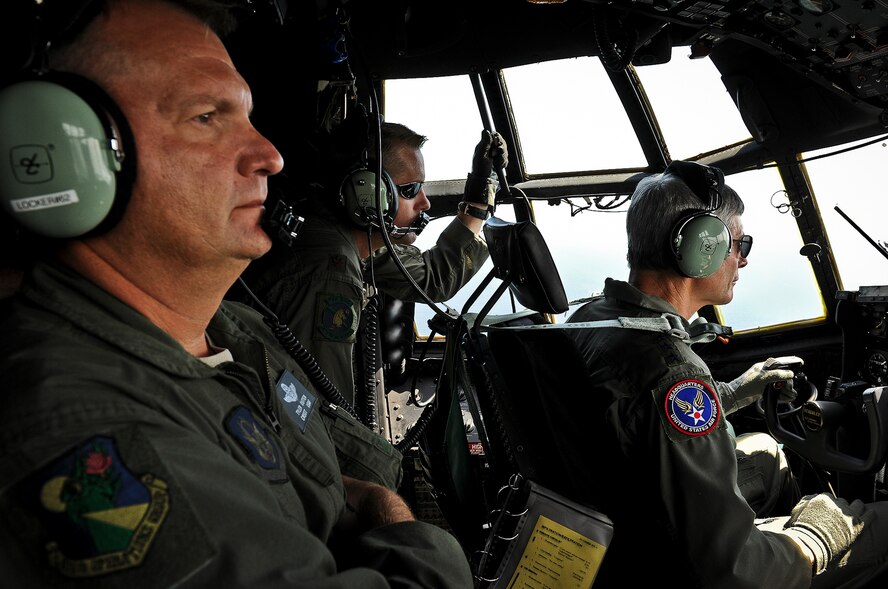 Chief Master Sgt. Tyler Outten and Maj. William Palmatier watch as Air Force Chief of Staff Gen. Norton Schwartz flies an MC-130E Combat Talon I July 12, 2012, during his last flight as an active duty officer. The MC-130E Combat Talon I crew conducted a local training sortie during the mission that also served as Schwartz’s “fini flight” in the Air Force. Outten and Palmatier are reservists with the 919th Special Operations Wing. (U.S. Air Force photo/Tech. Sgt. Samuel King Jr.)
