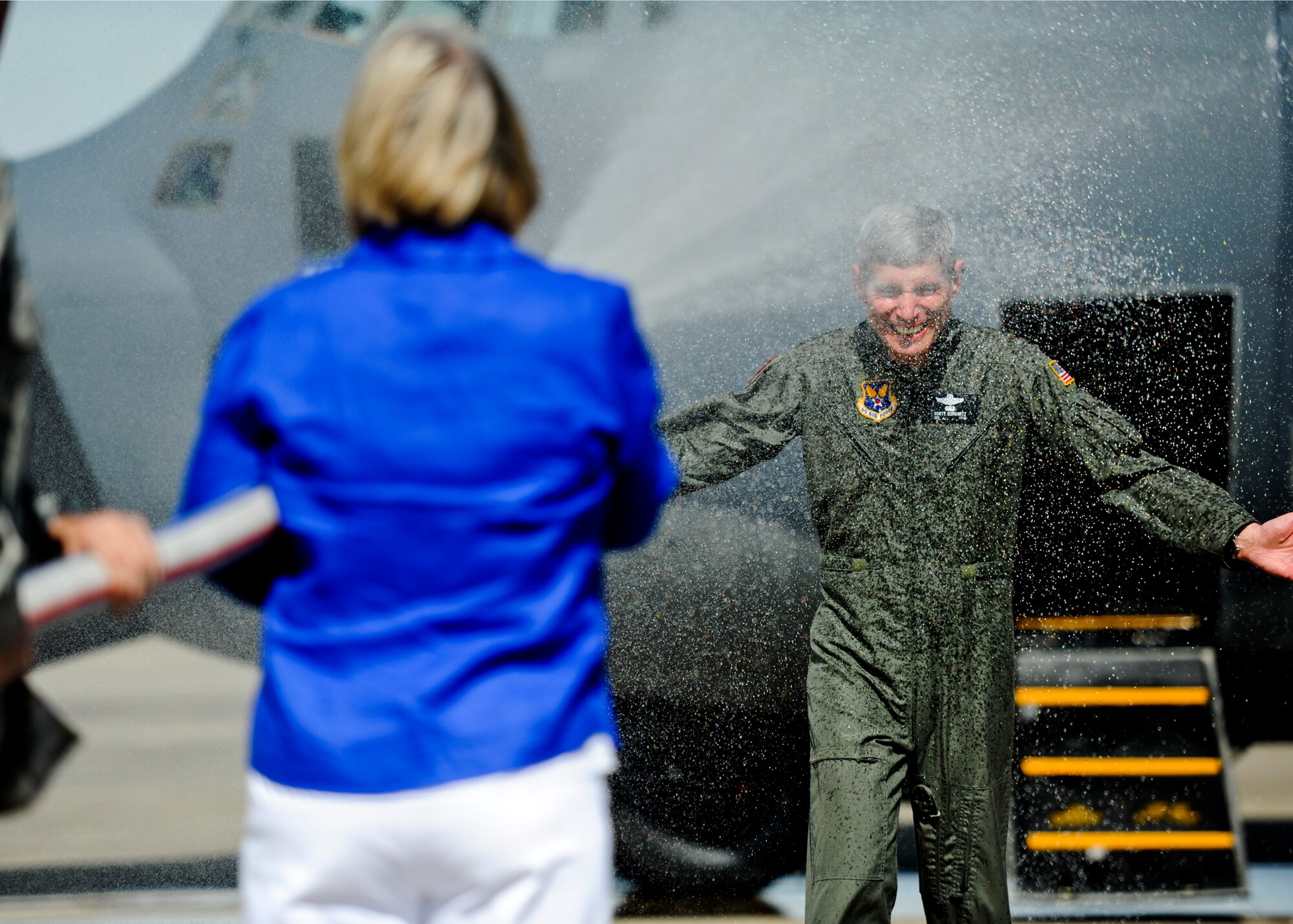 Air Force Chief of Staff Gen. Norton Schwartz gets “hosed down” by his wife Suzie  following his last flight as an active duty officer  at Hurlburt Field, Fla., July 12, 2012. The MC-130E Combat Talon I crew conducted a local training sortie during the mission. It also served as Schwartz’s “fini flight” in the Air Force. (U.S. Air Force photo/Staff Sgt. David Salanitri)
