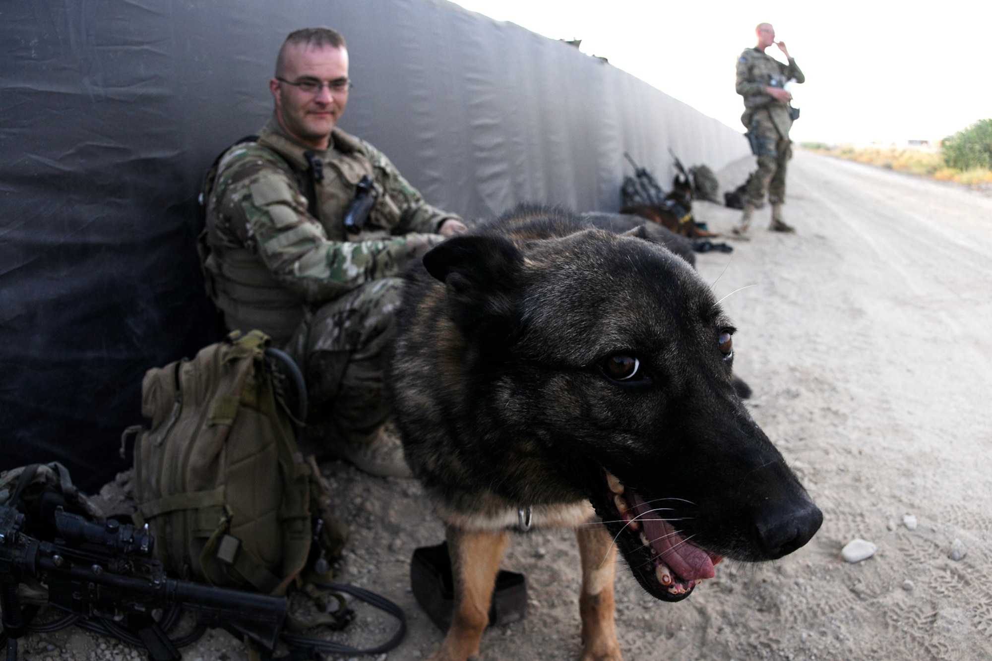 U.S. Air Force Tech. Sgt. Matthew Mosher, a Military Working Dog handler, and his dog, Zix, a Patrol Explosive Detection dog, prior to early-morning training on July 9, 2012 at Kandahar Airfield, Afghanistan. The handlers and their dogs rotate through Kandahar Airfield for validation prior to moving out to Forward Operating Bases around the country where they will lead combat foot patrols and sniff out IEDs and other explosives. (U.S. Air Force photo/TSgt. Stephen Hudson)