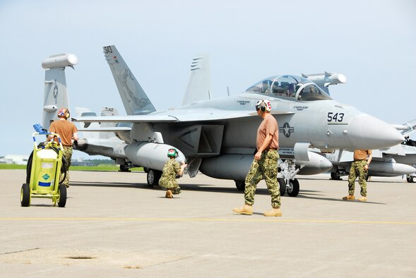 Electronic Attack Squadron (VAQ) 132 crew members conduct post-flight checks on an EA-18G Growler upon its arrival at Naval Air Facility Misawa, Japan, July 14, 2012.  VAQ-132 is beginning a six-month deployment on board NAF Misawa and will operate largely from this northern Japan-located U.S. naval installation.  (U.S. Navy photo by Mass Communication Specialist 2nd Class Pedro A. Rodriguez/Released)