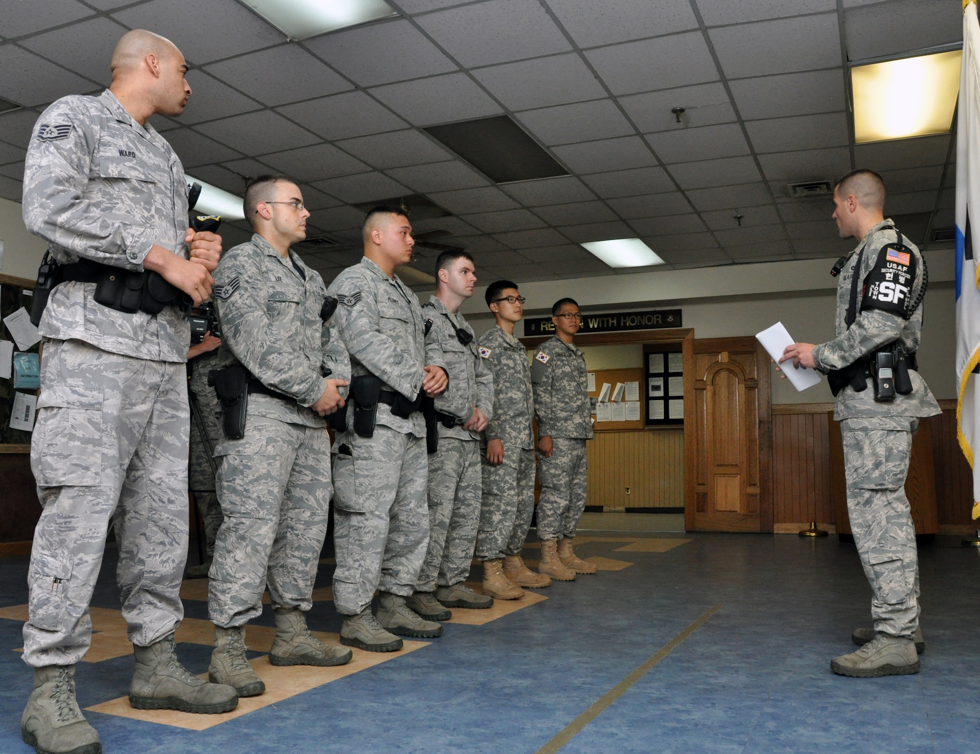 Master Sgt. Sloan Kalina, 51st Security Forces Squadron town patrolman, briefs security forces Airmen and Republic of Korea Army soldiers before a town patrol shift in Songtan, July 12, 2012. Town patrol routinely monitors areas just outside of Osan Air Base for force protection and enforcement of U.S. Forces Korea directives and regulations for people subject to the status of forces agreement and Uniform Code of Military Justice. The Korean Augmentees to the U.S. Army will help with language barriers and highlight the partnership between the U.S. military and Korean authorities. (U.S. Air Force photo/Senior Airman Michael Battles)