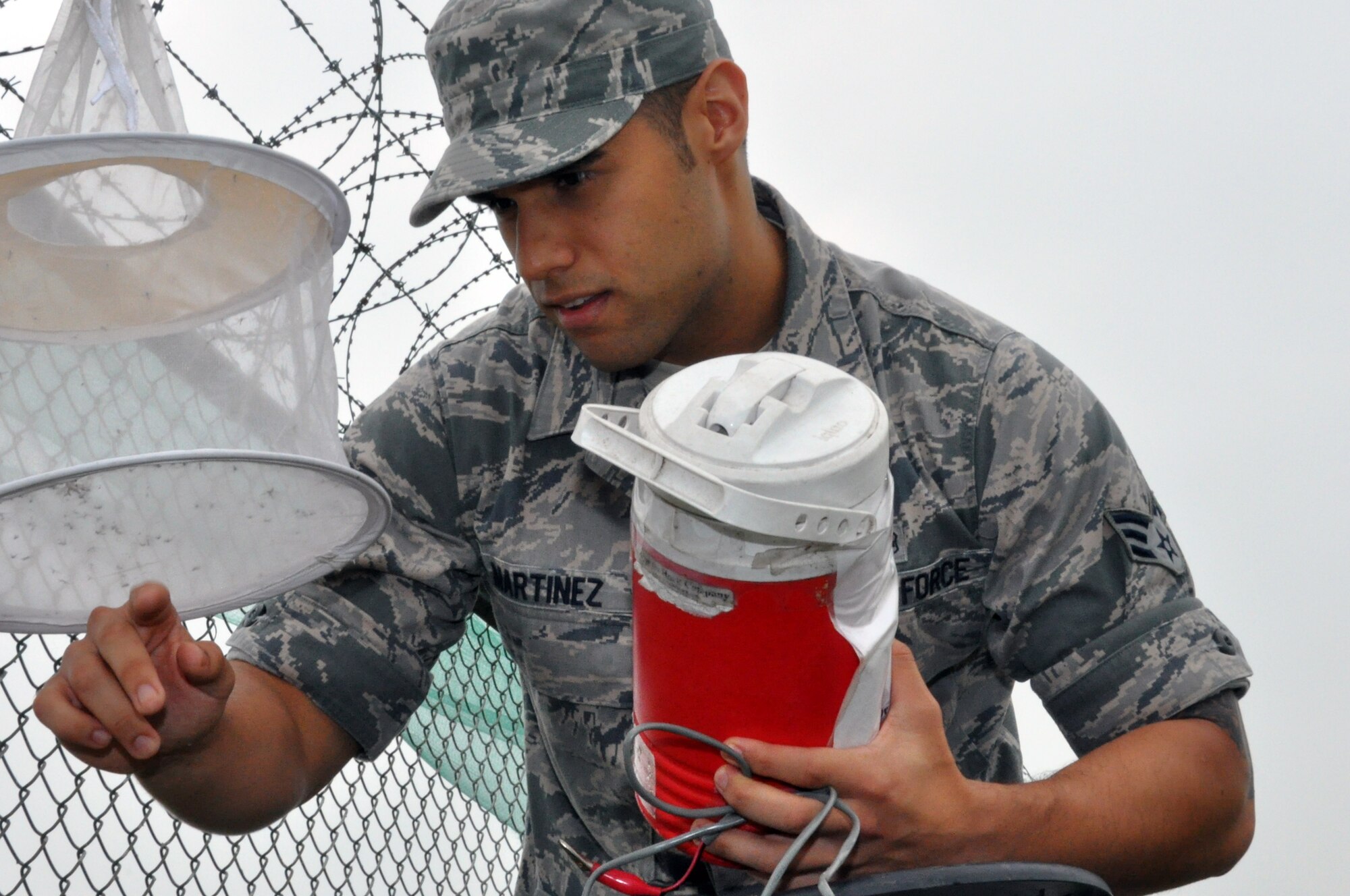 Senior Airman Rene Martinez, 51st Aerospace Medicine Squadron Public Health technician, inspects a mosquito net at Osan Air Base, Republic of Korea, July 12, 2012. The Public health office inspects 15 different locations around Osan for mosquitoes. From May to October each year the office watches for concentrations of mosquitoes. (U.S. Air Force photo/Senior Airman Michael Battles)