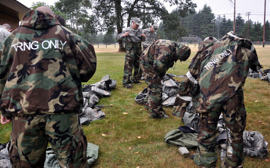 MCCHORD FIELD, Wash. - Reservists from the 446th Security Forces Squadron here, practice Mission-Oriented Protective Posture level two, or MOPP 2, by donning chemical, biological, radiological, nuclear and high-yield explosive protective wear, July 14.  The 446th SFS is preparing for their unit’s first ever participation in an Operational Readiness Inspection at Volk Field, Wis., in October. (U.S. Air Force photo by Tech. Sgt. Elizabeth Moody)