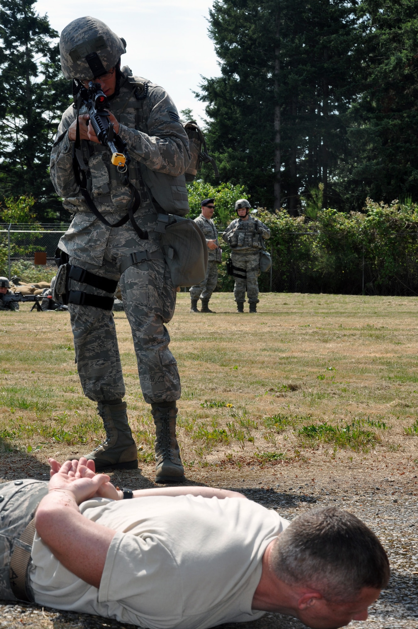 MCCHORD FIELD, Wash. - Senior Airman Devin Britton, 446th Security Forces Squadron, detains a mock suspect played by Tech. Sgt.  Eric Ellis, 446th SFS, while training here, July 14.  Reservists from the 446th SFS are preparing for their unit’s first ever participation in an Operational Readiness Inspection at Volk Field, Wis., in October. (U.S. Air Force photo by Tech. Sgt. Elizabeth Moody)