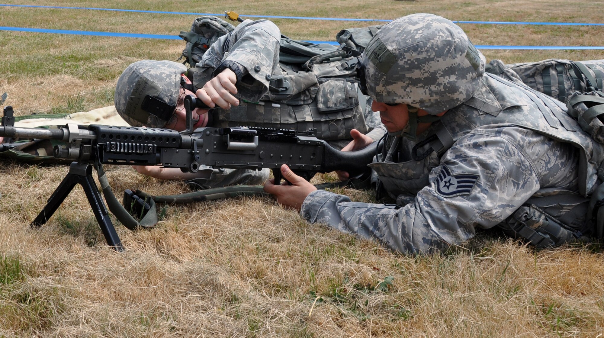 MCCHORD FIELD, Wash. - (Left to right) Senior Airman James Trevizo and Staff Sgt. Samuel Roman, 446th Security Forces Squadron here, practice barrel changes on an M240 7.62mm machine gun from a defensive fighting position while training July 14.  Reservists from the 446th SFS are preparing for their unit’s first ever participation in an Operational Readiness Inspection at Volk Field, Wis., in October. (U.S. Air Force photo by Tech. Sgt. Elizabeth Moody)