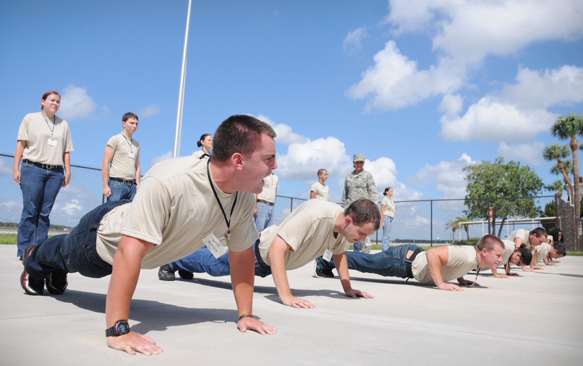 Members of the 927th Air Refueling Wing's Development Training Flight push the cement at a training session July 14, 2012 at MacDill Air Force Base, Fla. The Development Training Flight prepares newly-enlisted members for Air Force basic military training. 