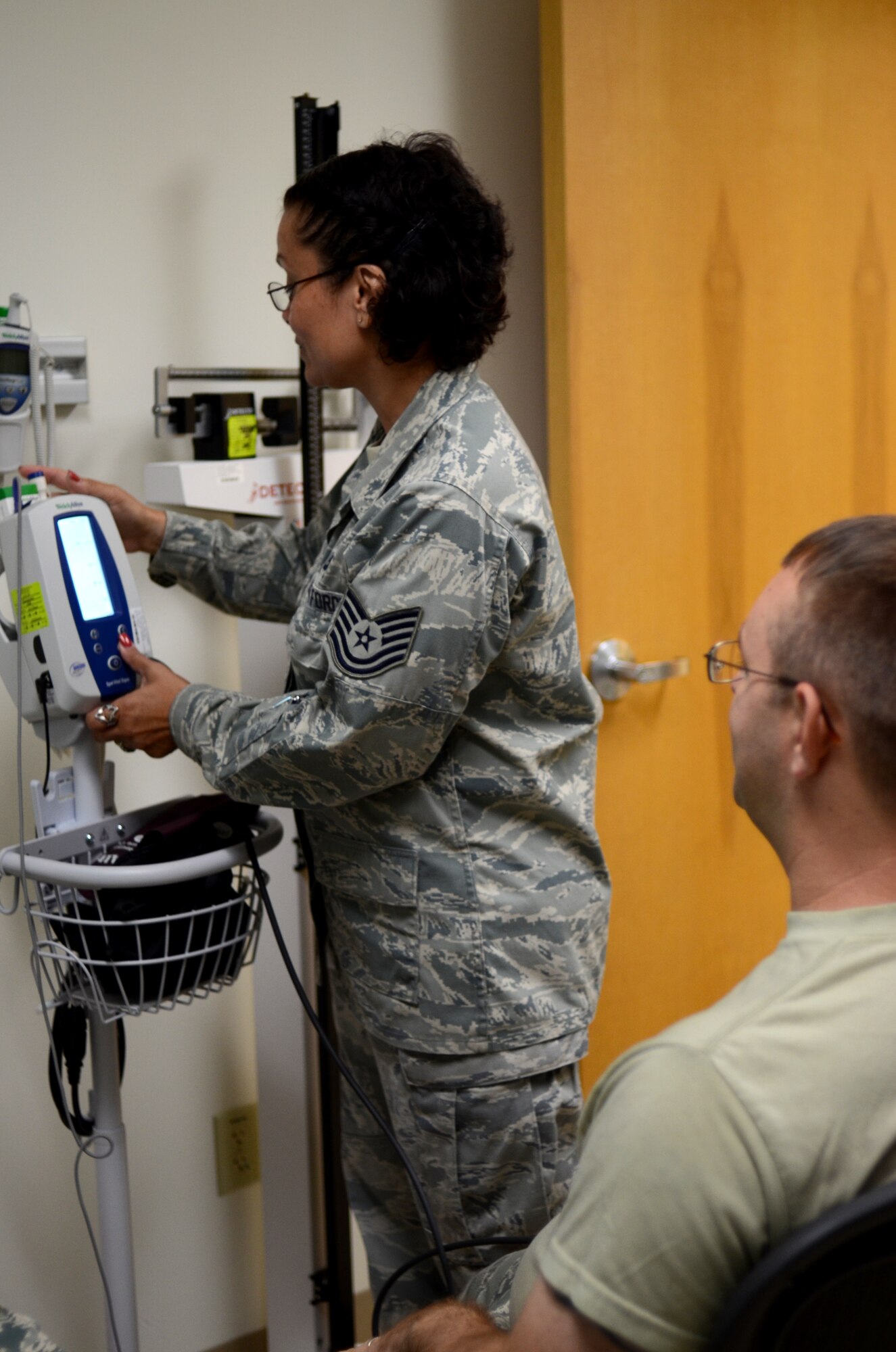 Tech. Sgt. Suellen Carire, 920th Aeromedical Staging Squadron, medic, records Staff Sgt. Jason Buzard, 920th Maintenance Squadron, hydraulics mechanic, vitals during a physical over the 920th Rescue Wing's monthly Unit Training Assembly. It is with the help of the Reservists from 920th ASTS that 920th RQW Airmen can deploy at a moment’s notice. (U.S. Air Force photo/Senior Airman Natasha Dowridge)