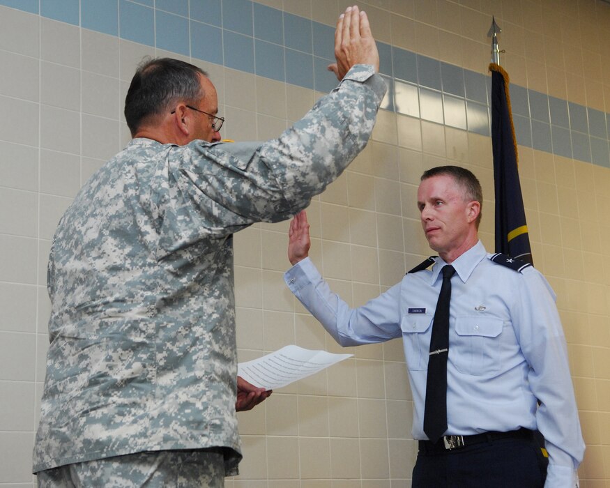 Maj. Gen. Brian Tarbet, the Adjutant General for Utah, administers the oath of office to newly promoted Brig. Gen. Kenneth L. Gammon, Chief of Staff, Utah Joint Force Headquarters Air, on July 14, 2012, at the Utah Air Guard base in Salt Lake City, Utah. (U.S. Air Force photo by Master Sgt. Gary J. Rihn)(Released)